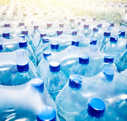 Many bottles of water shrink-wrapped in groups of 6.