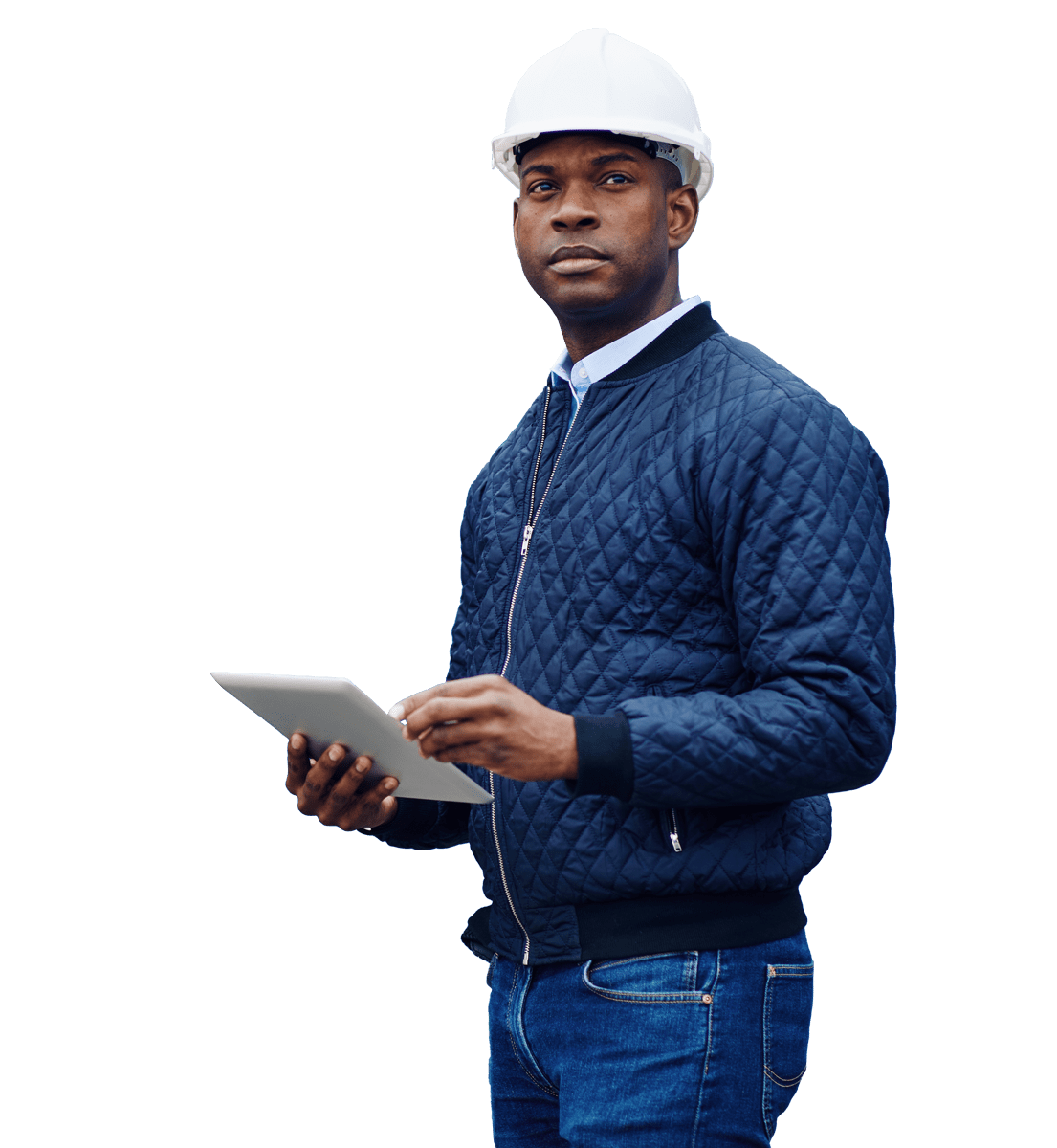 A man in a hard hat and jacket holding a tablet.
