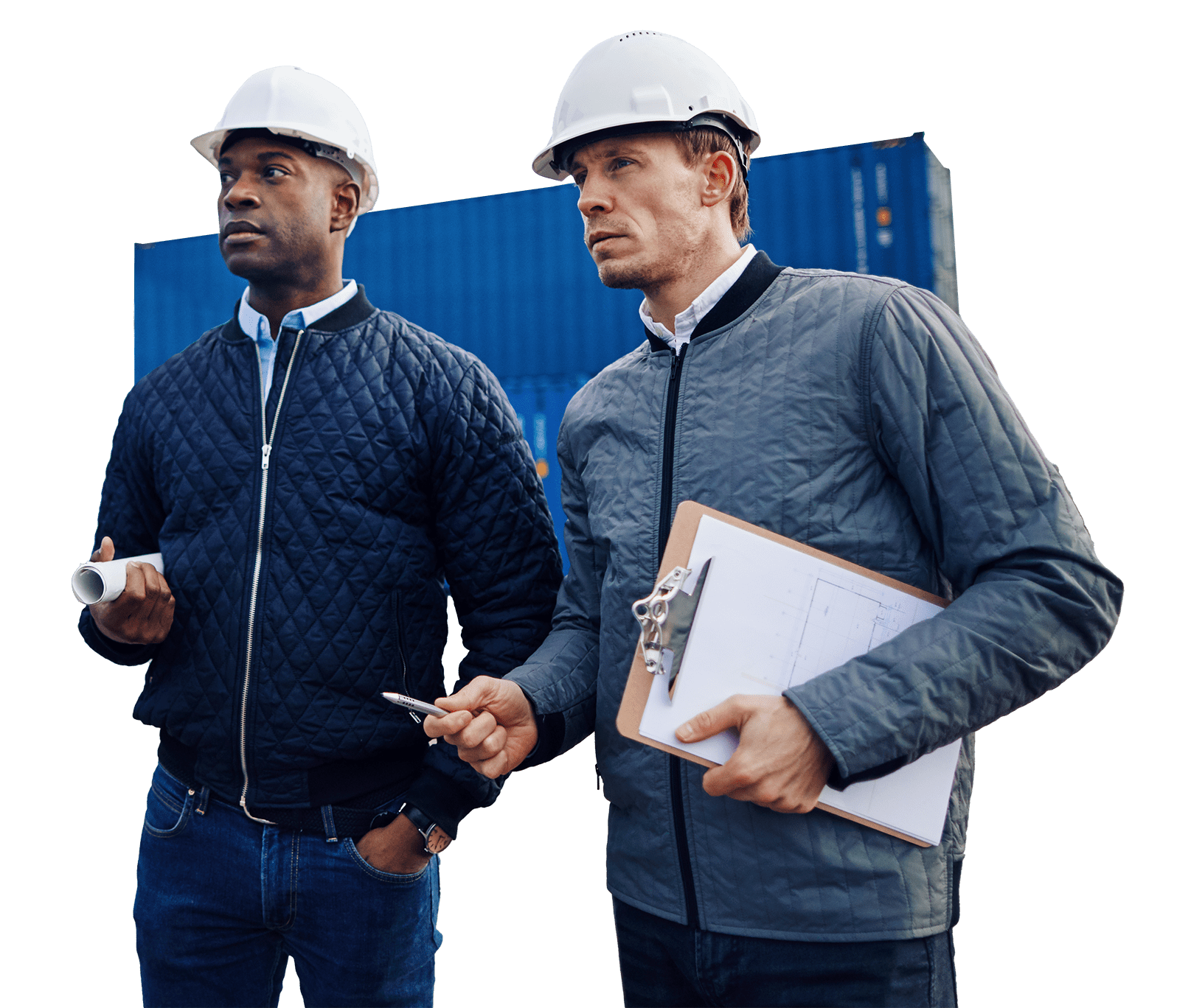 Two men with hard hats and jackets. One has a roll of papers under his arm and the other is holding a clipboard and a pen.